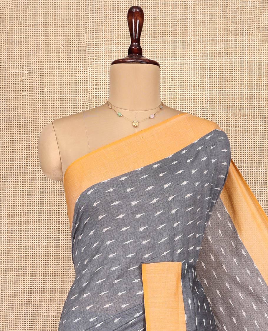 Grey Ikkat Cotton Saree, Decked Up with Ikkat-Style Buttas on Its Body, Complemented by Contrast Border, Pallu Steeped with Ikkat Buttas, and Has No Blouse