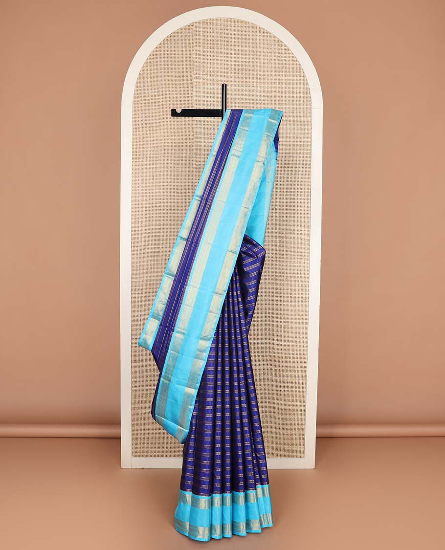 Blue zari striped Kanchipuram silksaree, contrast rettai pettu border of traditional zari designs, and zari-rich jaal pallu