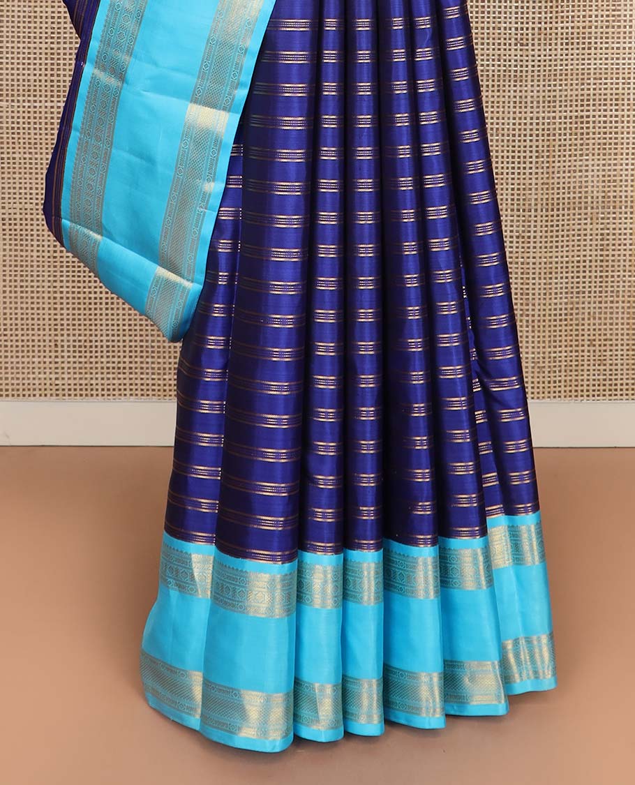Blue zari striped Kanchipuram silksaree, contrast rettai pettu border of traditional zari designs, and zari-rich jaal pallu