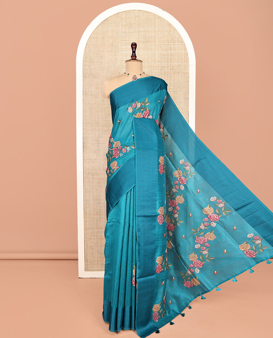 Rama Blue Green-Silk Saree, Colorfully Highlighted with Rose Motifs Cross Stitch Embroidery on Its Body, Subtly Sparkled by a Plain Border, Pallu of Rose Cross Stitch Embroidery, and Paired with a Contrast Blouse