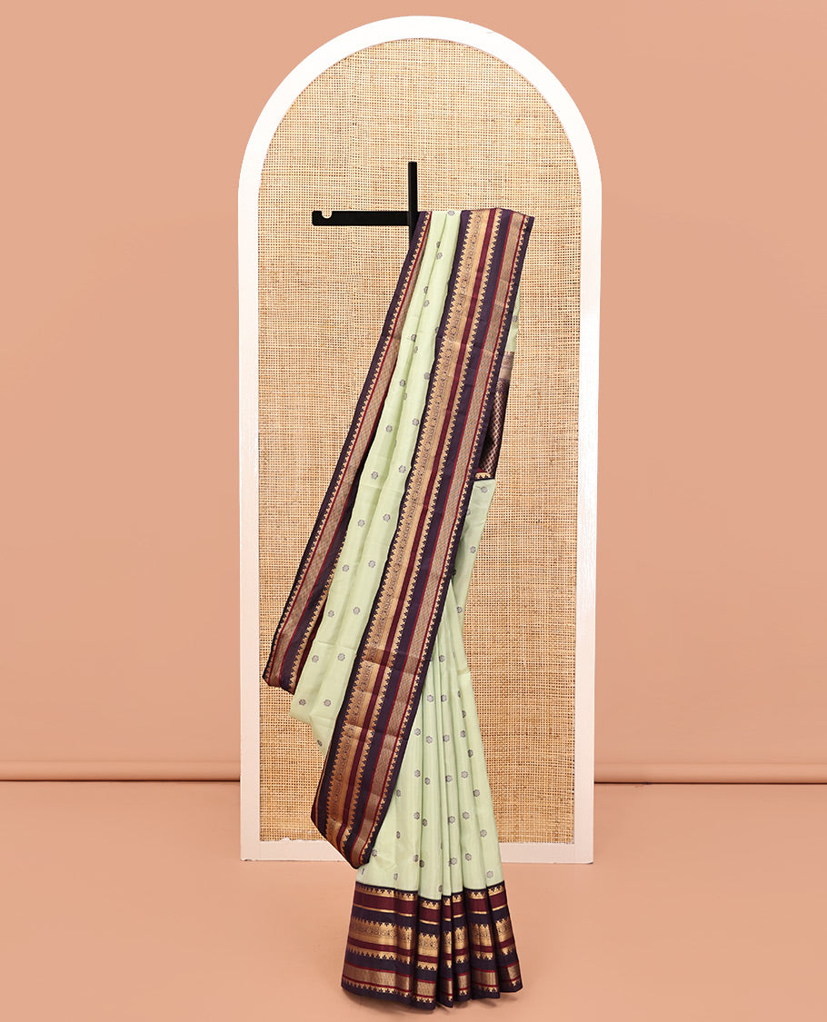 Pista Green and Coffee Brown Vasundenhara Lite Silk Mix Saree, Subtly Adorned with Buttas All Over Its Body, Complemted by Contrast Border of Thazampoo Rekku, Banaras, Jada Nagam, and Ara Maadam Designs, Grand Pallu, and Paired with a Contrast Blouse