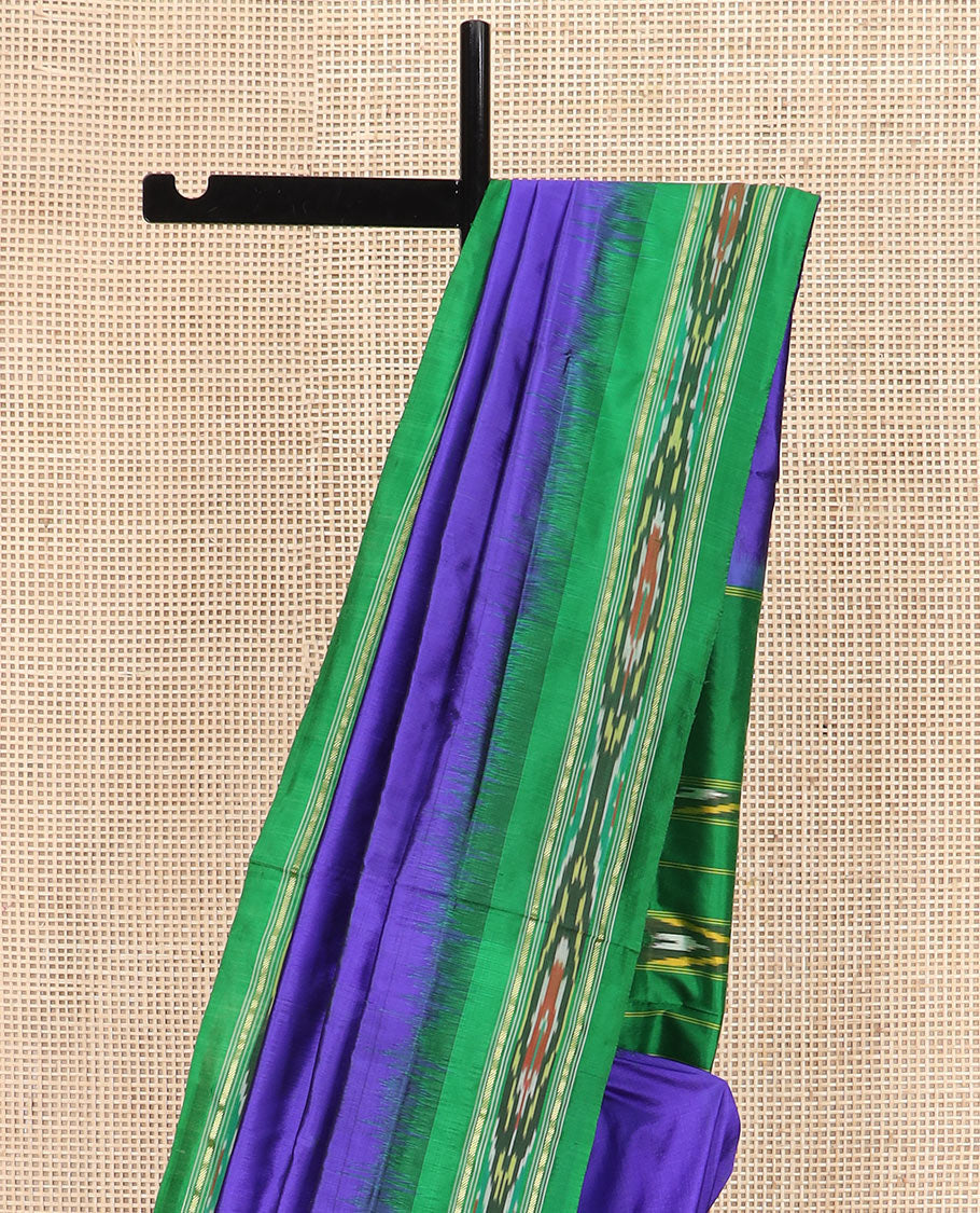 Violet Plain Ikkat Silk Saree with a Contrast Green Border Adorned by a Hazy Ikkat Weave, Featuring a Pallu Flanked by Stripes and Ikkat Texture