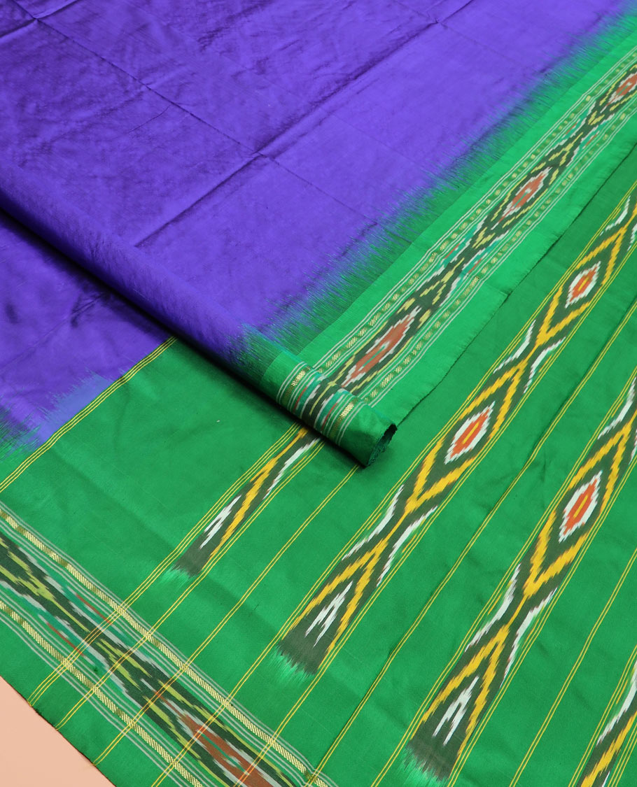 Violet Plain Ikkat Silk Saree with a Contrast Green Border Adorned by a Hazy Ikkat Weave, Featuring a Pallu Flanked by Stripes and Ikkat Texture