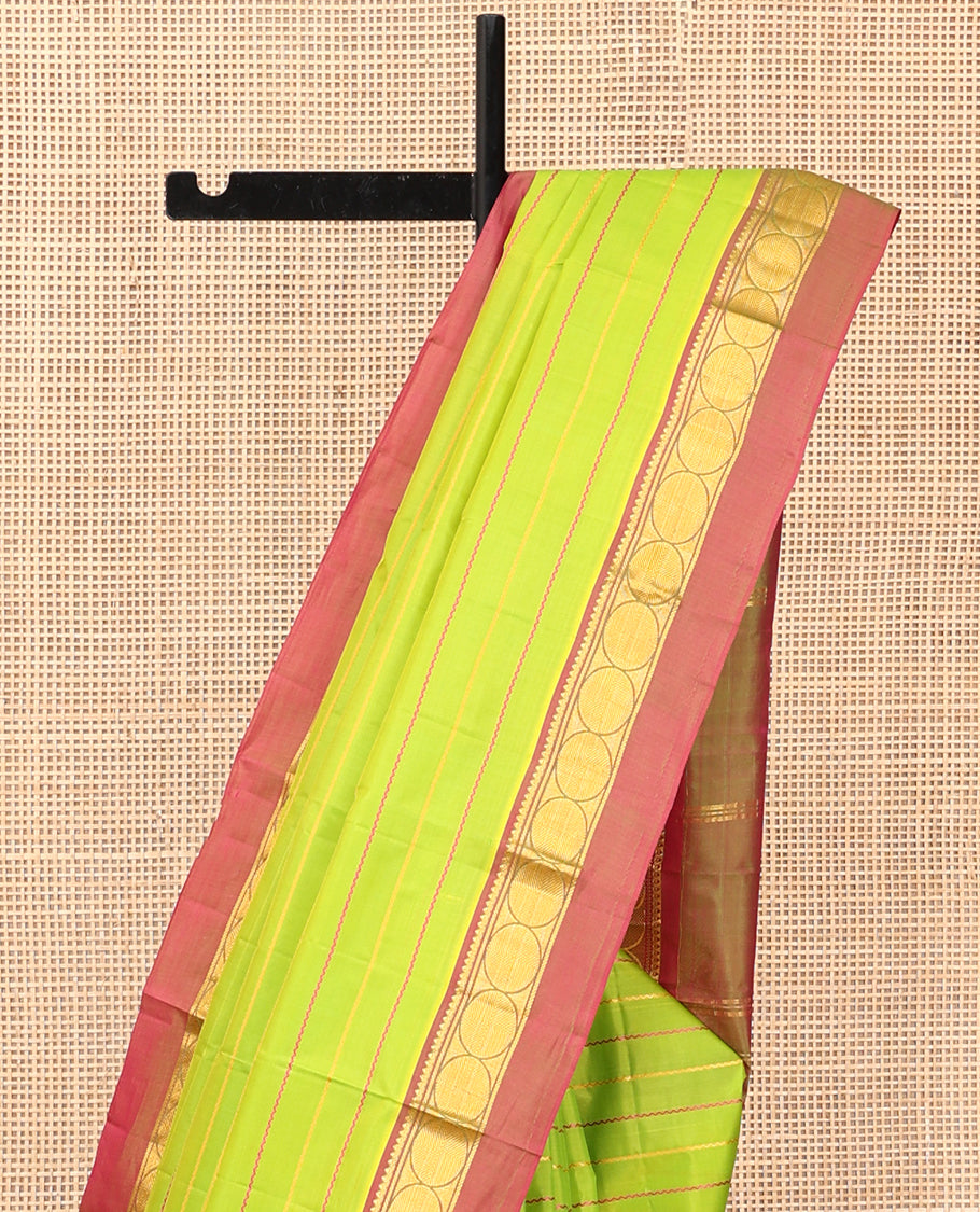 Green Veldhari Striped Kanchipuram Silk Saree, Complemented by a Contrast Kal Eragina Border of Thilakam Mokku, and Rudraskham Design, Pallu of Zari Stripes, and a Contrast Blouse