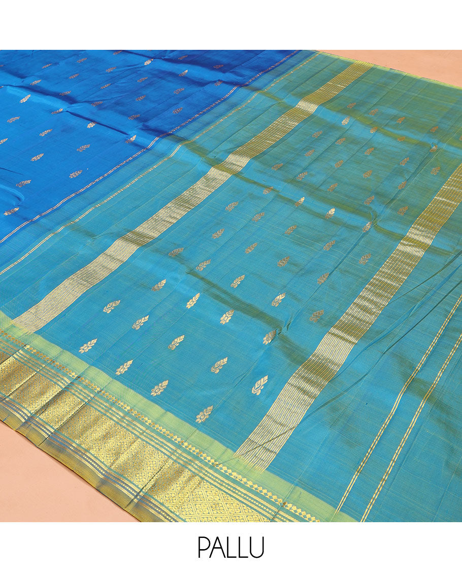 Blue Kanchipuram Silk Saree, Spotlighted with Zari Buttas on Its Body, Complemented by Contrast One-Sided Border of Panner Sombu, Banaras, Muthu, and Jaal Designs, Pallu Features Zari Designs, and Comes Without a Blouse