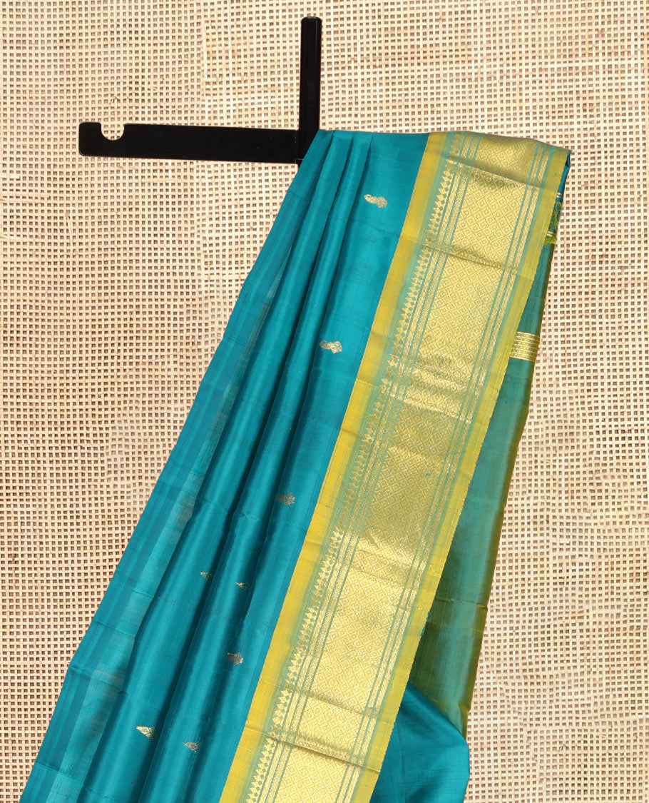 Green Kanchipuram Silk Saree, Adorned with Zari Buttas, Complemented by a Contrast One-Sided Border of Panner Sombu, Banaras, and Mayil Kann Designs, Zari Woven Pallu, and a No Blouse
