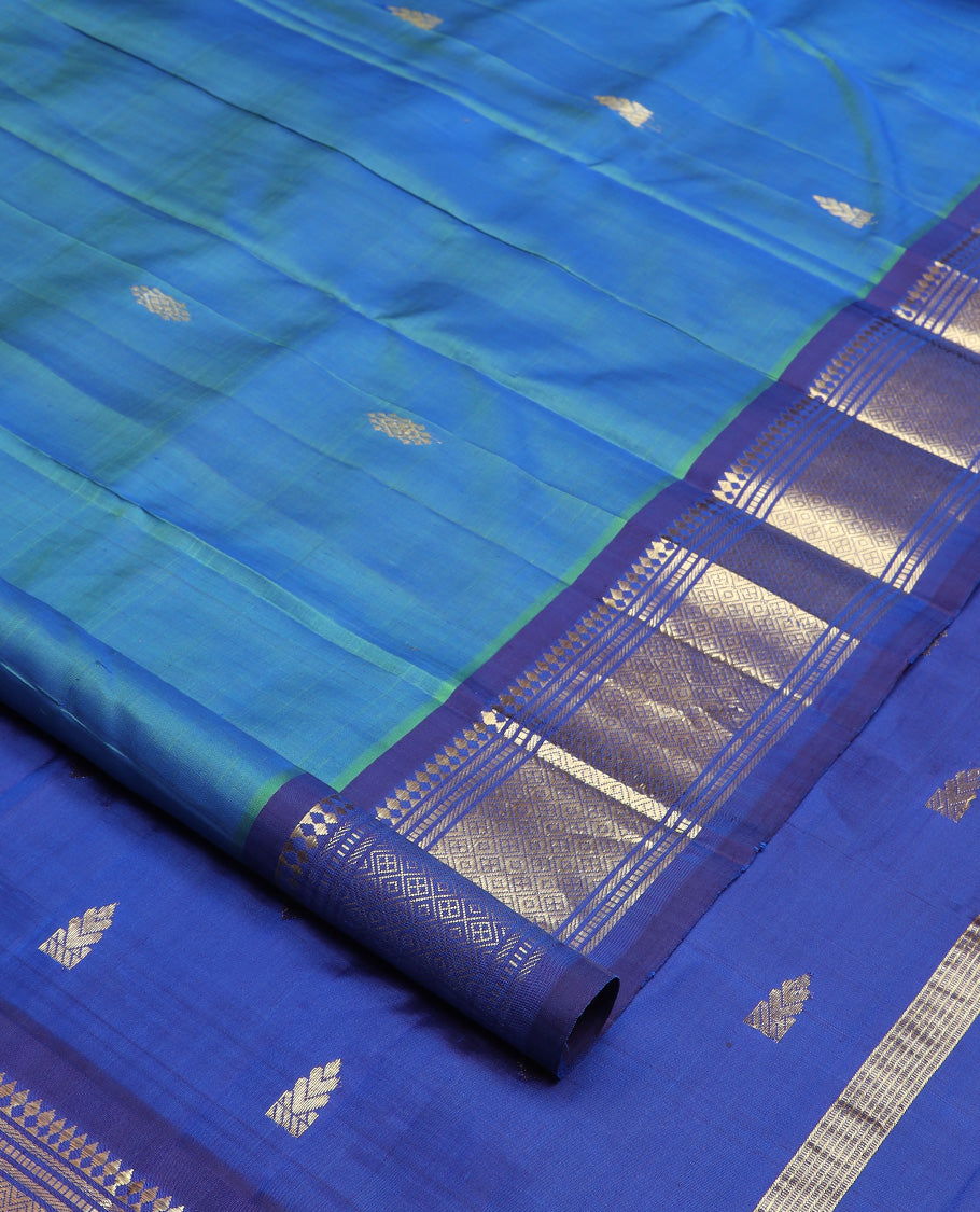 Blue zari buttas Kanchipuram silk saree, contrast one-sided border of paneer sombu, banaras, muthu and jaal design, and zari design pallu