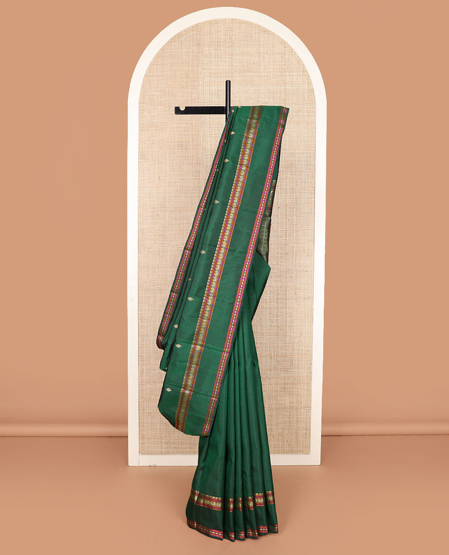 Green buttas Kanchipuram silk saree, rettai pettu border of manga, neli, mayil, and rudraksham designs, and jaal pallu