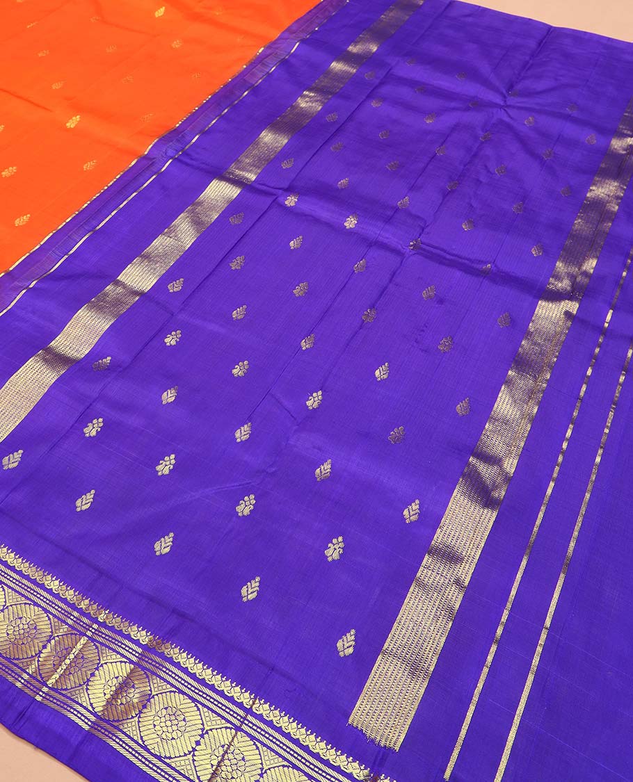 Orange zari buttas Kanchipuram silk saree, contrast one-sided thazampoo rekku border of salangai, banaras, muthu, and poo chakram designs, and zari design pallu