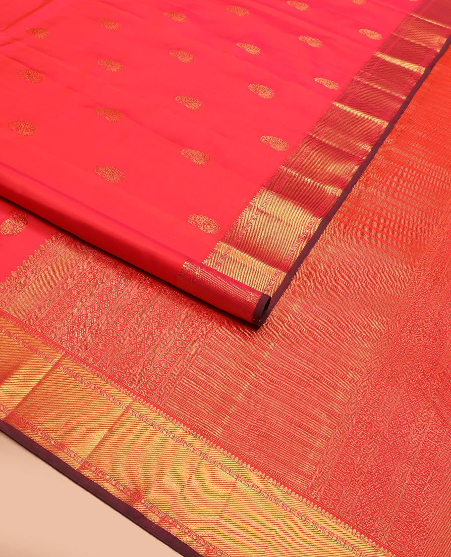 Red manga buttas Kanchipuram silk saree, zari border of thilakam mokku, zari stripes, and manga designs, and geometric patterned pallu