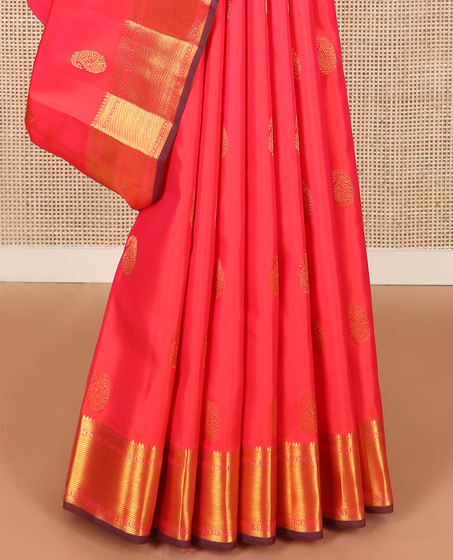 Red manga buttas Kanchipuram silk saree, zari border of thilakam mokku, zari stripes, and manga designs, and geometric patterned pallu
