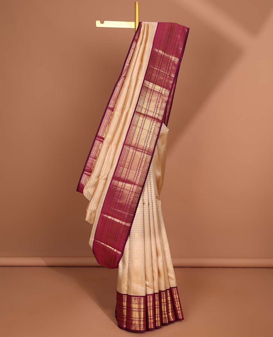 Cream striped kancheepuram silk saree with intricate zari pallu & korvai border of rekku,muthu,manga, vanki designs