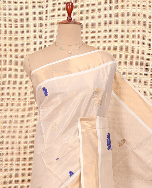 Cream Kerala Cotton Saree, Elevated with Thread and Zari Buttas All Over Its Body, a Zari Bavanji Border, Pallu of Elephant Designs, and Paired with a Matching Blouse