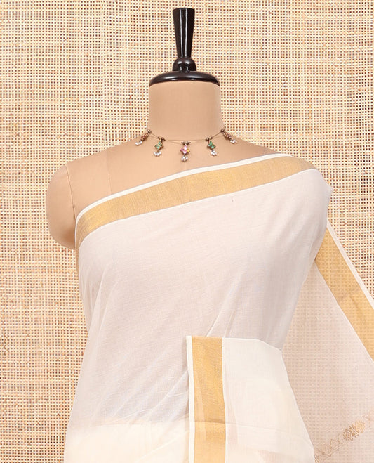 Cream Kerala Cotton Saree, Ornamented with Zari Stripes All Over Its Body, a Subtle Bavanji Border, Pallu of Paisley Designs, and Is Paired with a Matching Blouse