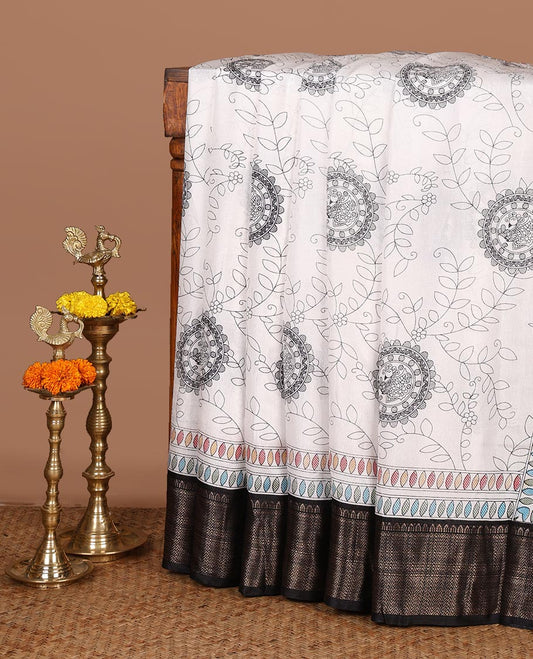 Black with white kalamkari printed dola silk saree, contrast jacquard border & madhubani printed pallu along with floral printed blouse