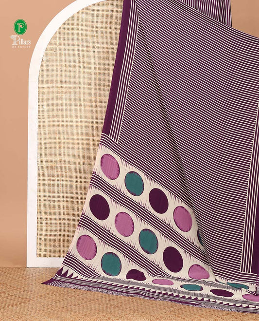 Purple vertical stripes printed modal satin saree, a self-border of horizontal stripes print, polka dots printed on the pallu, and an intricate ajrakh-style printed blouse