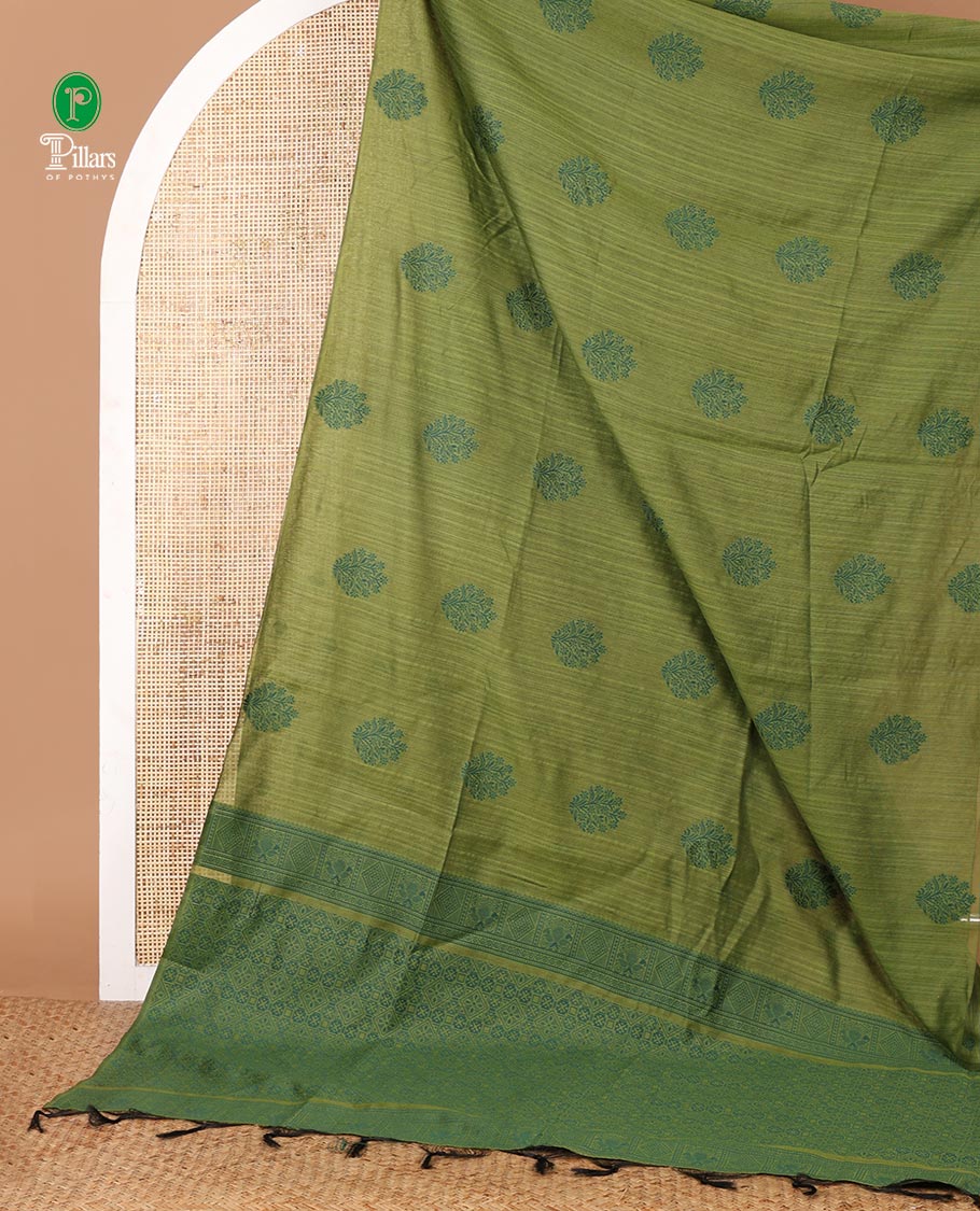Borderless olive green banaras jute silk saree with floral thread buttas woven all over it's body, intricate pallu & butta design blouse