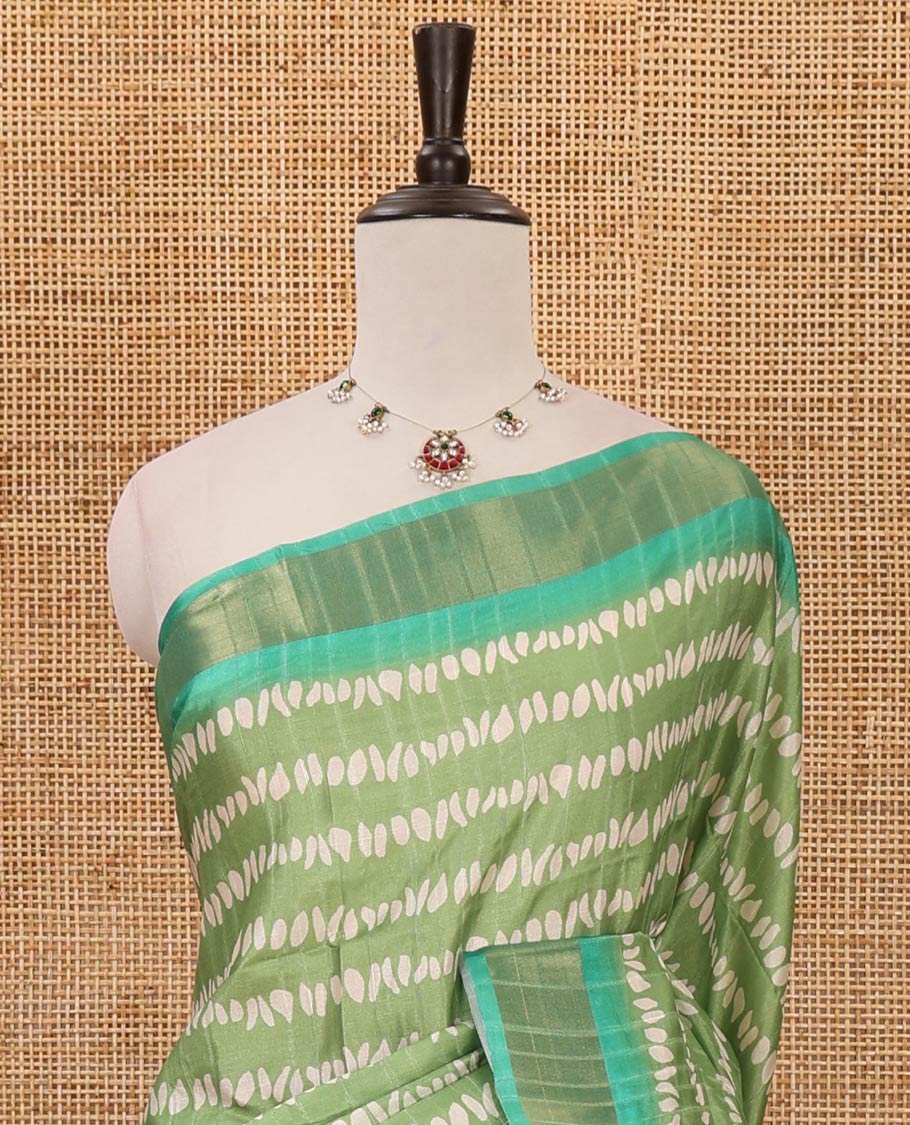 Green uniquely printed soft tussar saree, contrast zari border, kalamkari floral vine printed pallu & kalamkari printed blouse