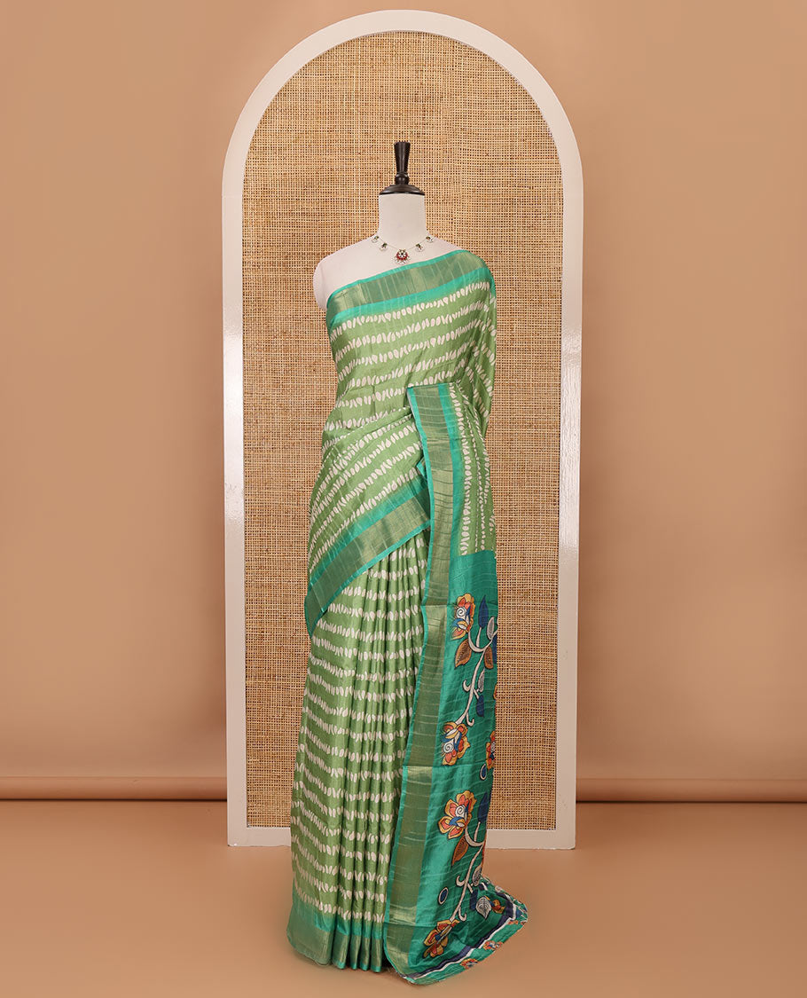 Green uniquely printed soft tussar saree, contrast zari border, kalamkari floral vine printed pallu & kalamkari printed blouse