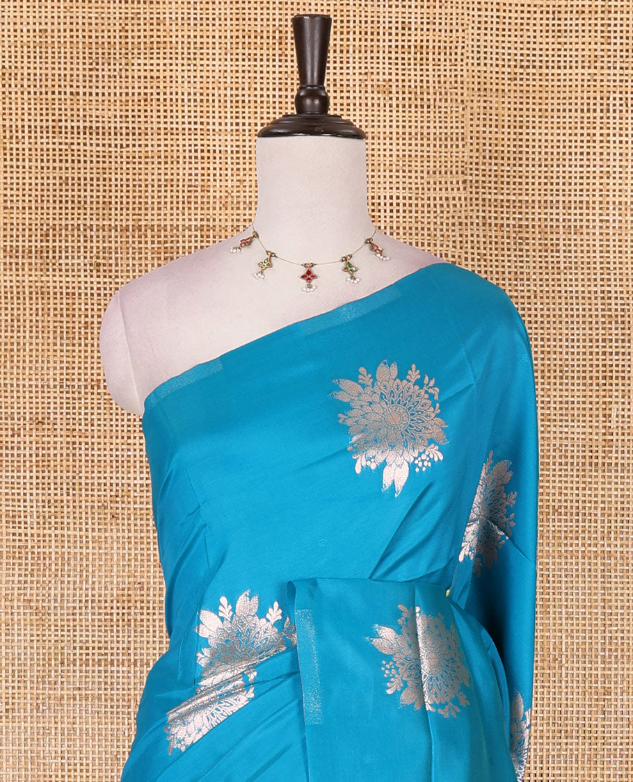 Borderless blue floral motifs steeped elite soft silk saree, contrast lotus-like motifs pallu, and contrast buttas blouse