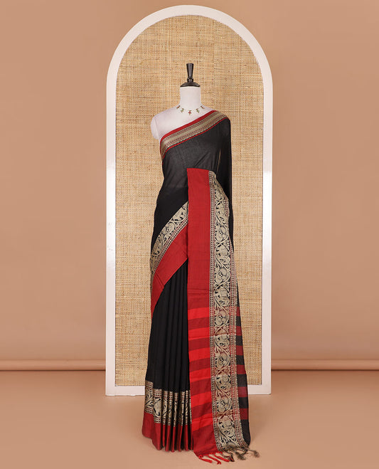 Black plain mercerised cotton saree, contrast traditional border of peacock, and elephant motifs, striped pallu, and a matching blouse