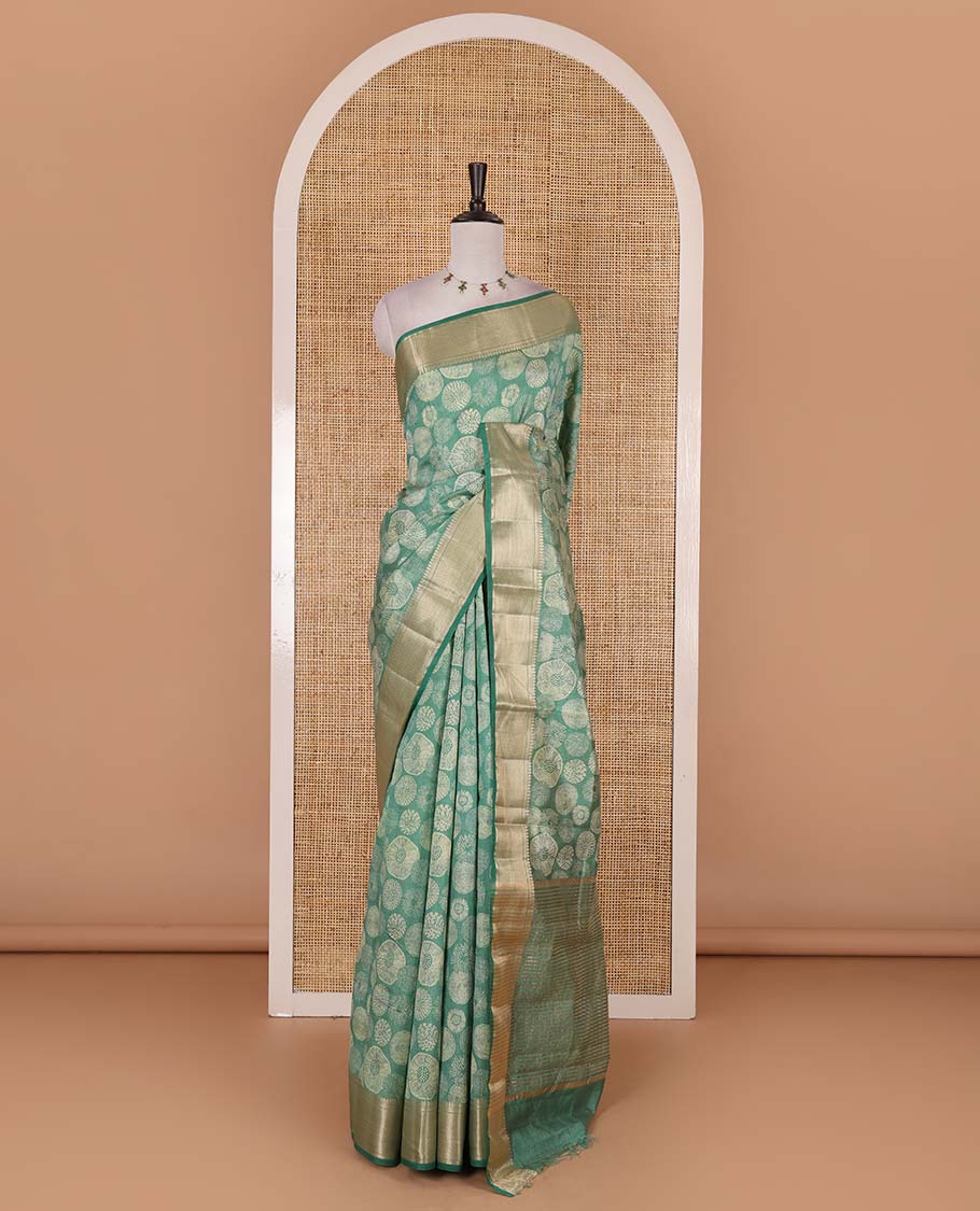 Green uniquely printed semi-tussar saree, traditional zari border, zari striped pallu, and a matching blouse