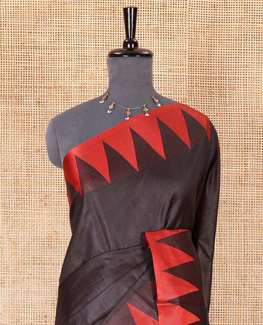 Black sparsely striped semi-tussar saree, contrast temple red border, striped pallu, and contrast blouse