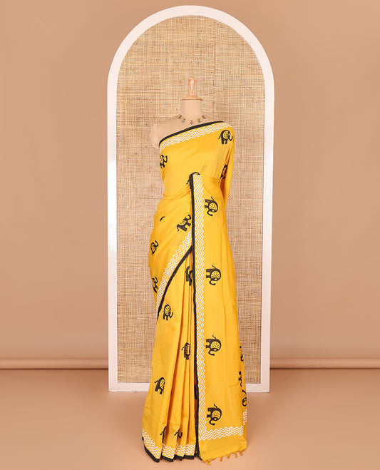 Yellow elephant motifs block printed South cotton saree, chevron stripes block printed border, a matching blouse, and a contrast floral vine printed blouse