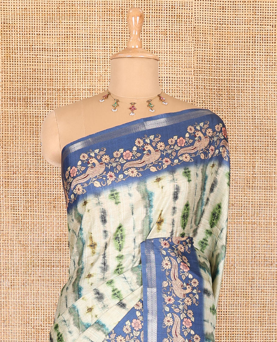 Green shibori printed katan silk saree, contrast border, and pallu of kalamkari floral vine and peacock print, and a contrast leaf printed blouse