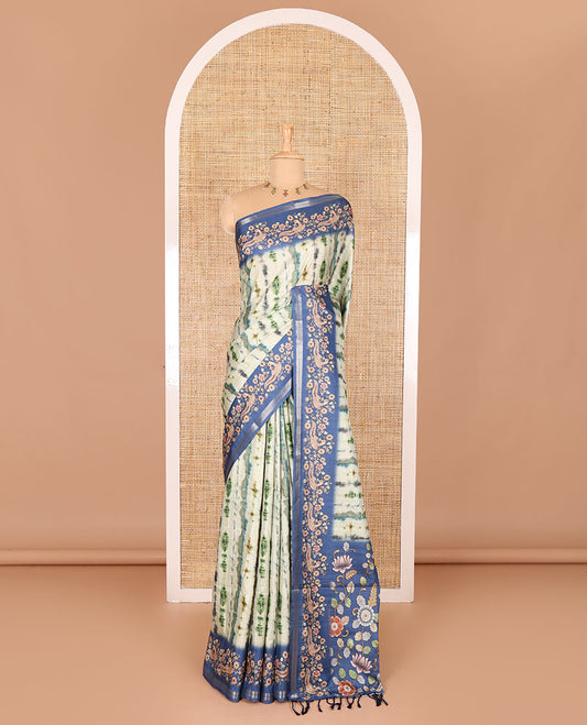 Green shibori printed katan silk saree, contrast border, and pallu of kalamkari floral vine and peacock print, and a contrast leaf printed blouse