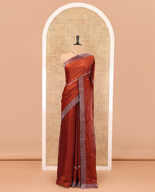 Rust color horizontally swarovski stone striped fendi chiffon saree, swarovski stone work border, and a plain blouse