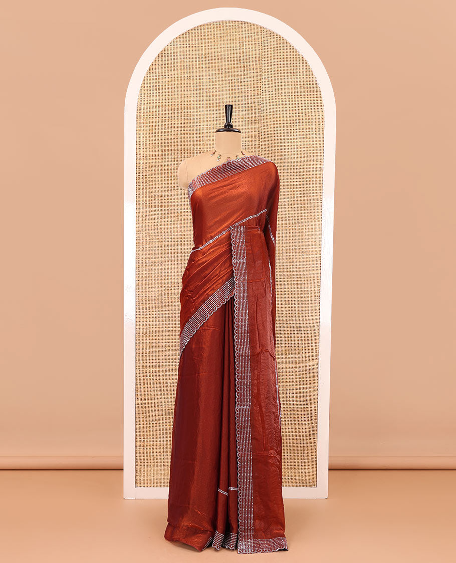 Rust color horizontally swarovski stone striped fendi chiffon saree, swarovski stone work border, and a plain blouse