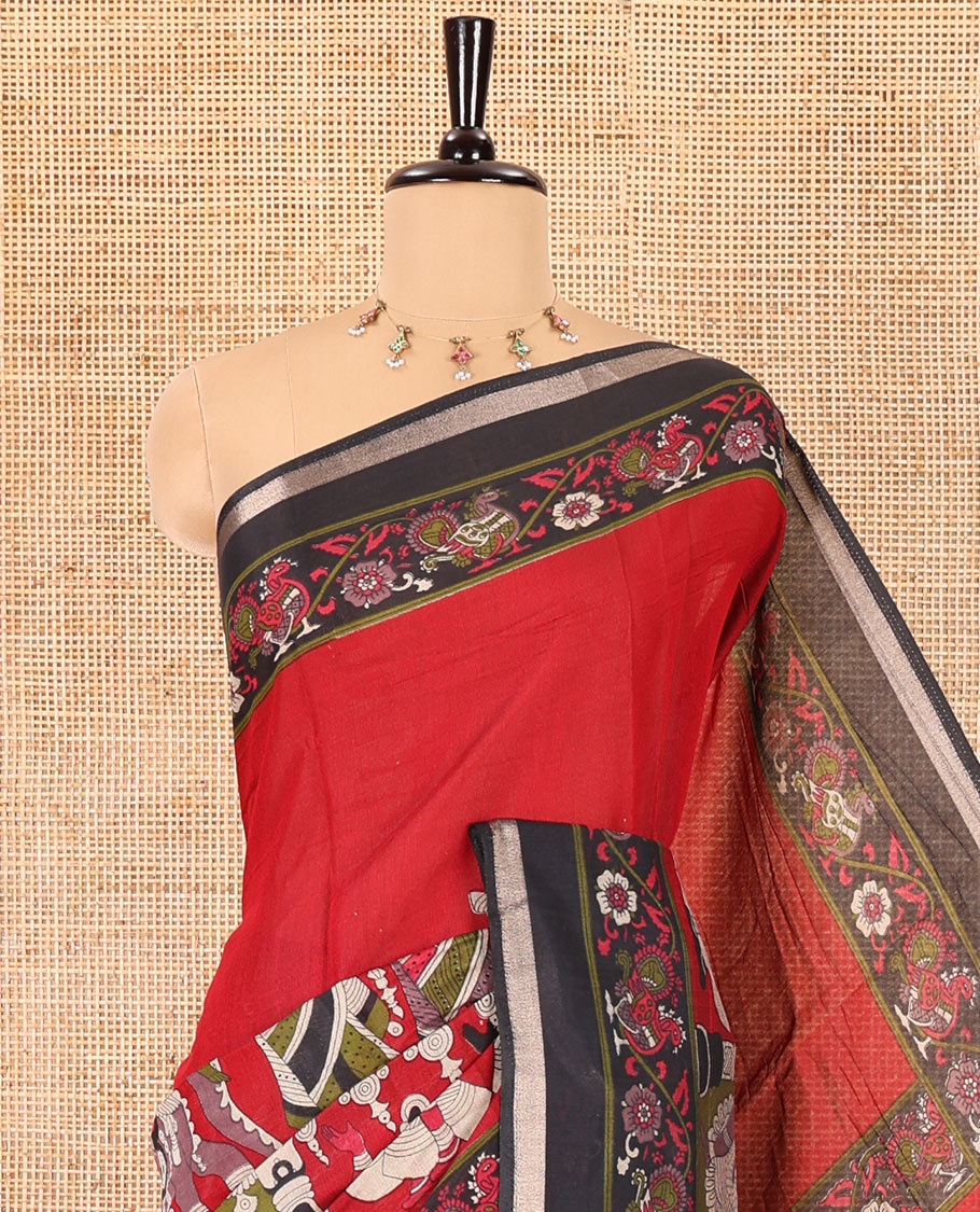 Red human figurines printed muslin cotton saree, contrast floral-peacock printed border of piping work, kalamkari printed pallu, and a contrast blouse of flower motifs print