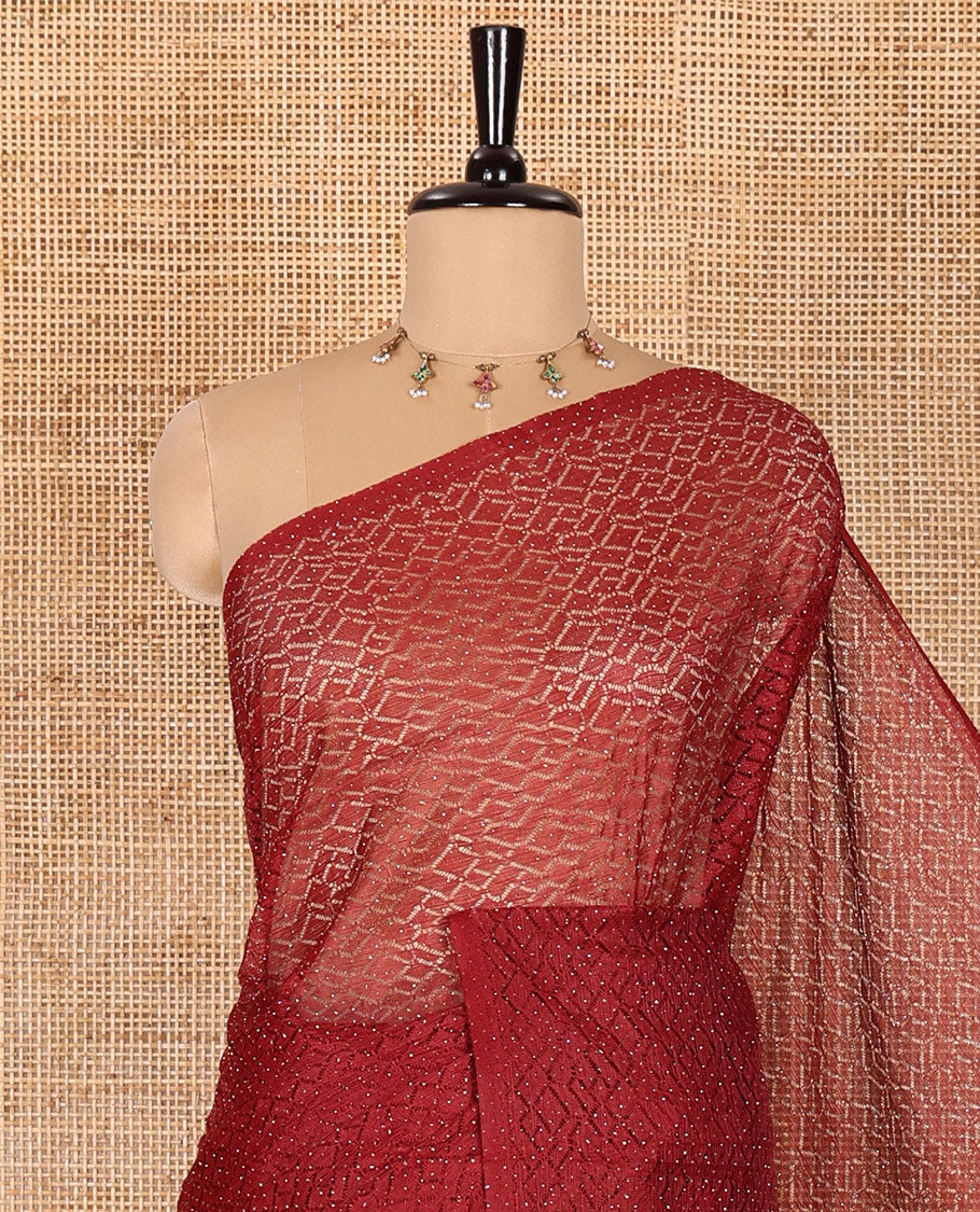 Borderless maroon sparkling glitter russel net saree with self-pallu, and a contrast floral printed and zig-zag patterned blouse