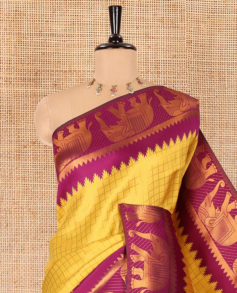 Yellow checked design litchi saree, contrast temple elephant motifs border, geometric patterned pallu, and a contrast jacquard blouse