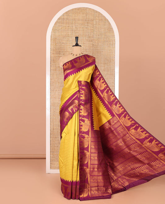 Yellow checked design litchi saree, contrast temple elephant motifs border, geometric patterned pallu, and a contrast jacquard blouse
