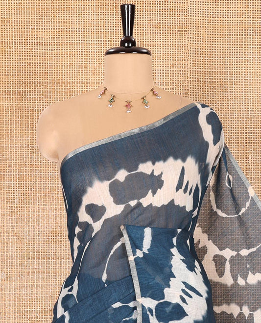 Borderless Petrol Blue Linen Cotton Saree Elevated with Shibori Prints, Complemented by Contrast Pallu Steeped with Floral Vine Print, and Paired with a Contrast Floral Printed Blouse