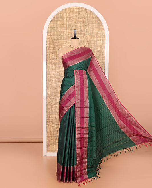 Green Plain Semi-Soft Silk Saree, Complemented by a Contrast Horizontally Zari Striped Border, Sparsely Striped Pallu, and a Matching Blouse
