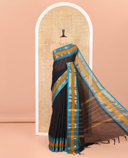 Black Plain Chettinad Cotton Saree, Complemented with a Contrasting Rettai Pettu Border of Peacock Chakram Motifs, a Subtle Pallu of Stripes, and a Matching Blouse