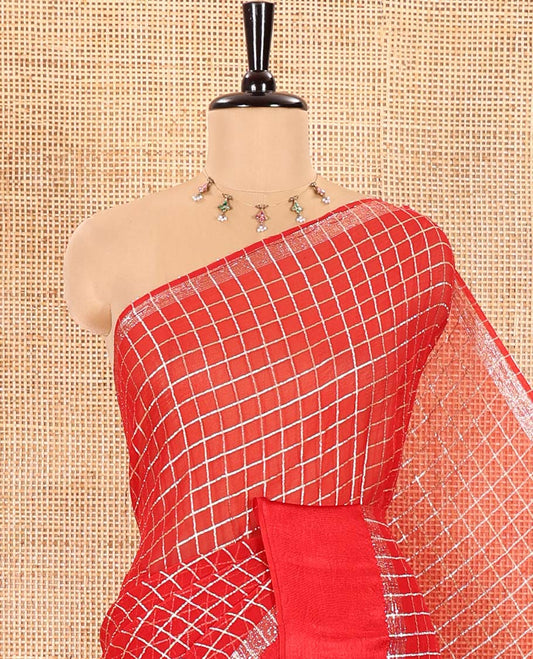 Red Viscose Georgette Saree Gleamed with Golden Zari Checks All Over Its Body, Adorned with a Satin Plain Border, a Self Pallu Featuring the Same Checks, and Paired with a Running Blouse