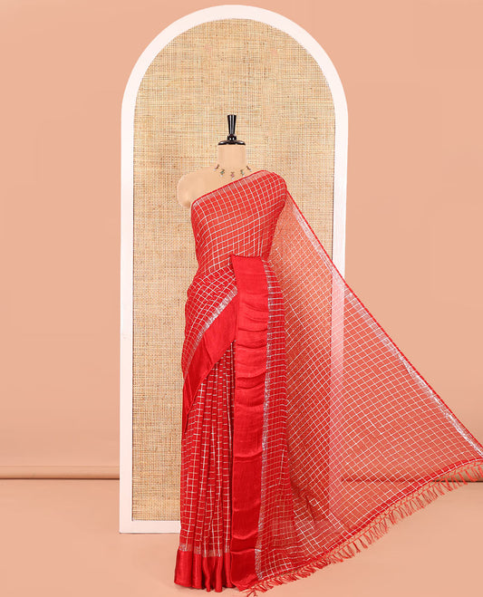 Red Viscose Georgette Saree Gleamed with Golden Zari Checks All Over Its Body, Adorned with a Satin Plain Border, a Self Pallu Featuring the Same Checks, and Paired with a Running Blouse
