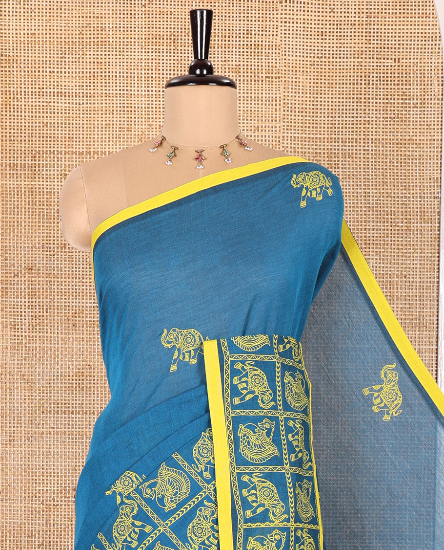 Blue Mangalagiri Cotton Saree Adorned with Elephant Motifs Block Print All Over Its Body, Subtly Printed Border of Animal Butta Enclosed Checks, Pallu Mirrors the Same Border Print, and Paired with a Contrast Printed Blouse