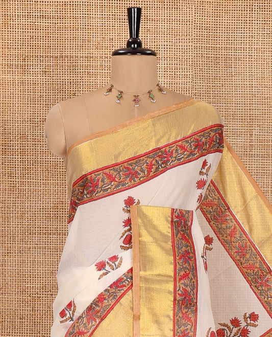 Cream Kerala Cotton Saree, Elevated with Floral Buttas Printed on Its Body, Highlighted by Gleaming Golden Zari Border, Pallu Features the Floral-Paisley Print, and Paired with a Matching Printed Blouse