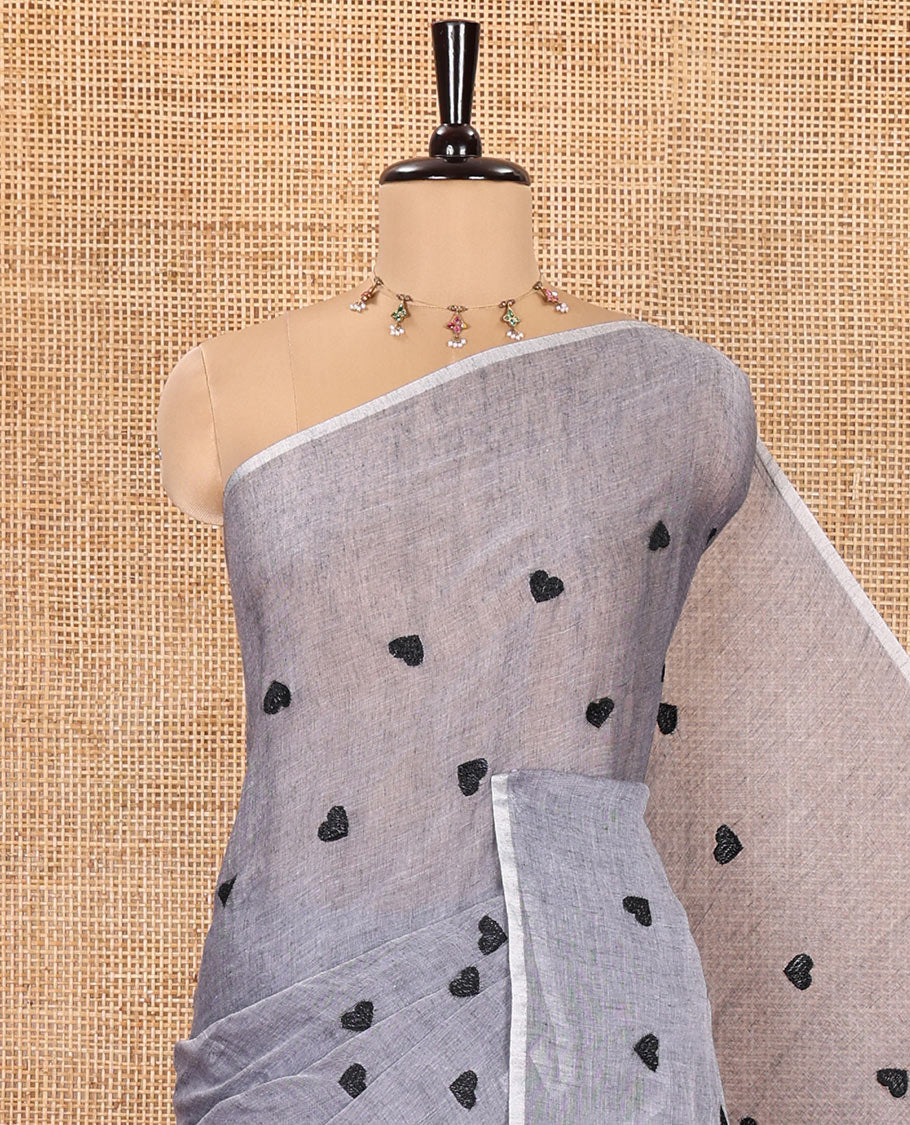 Borderless Grey Khadi Mul Cotton Saree, Artfully Designed with Heart Motifs Embroidery Across Its Body, Pallu mirrors the Same Design, and Paired with a Matching Blouse