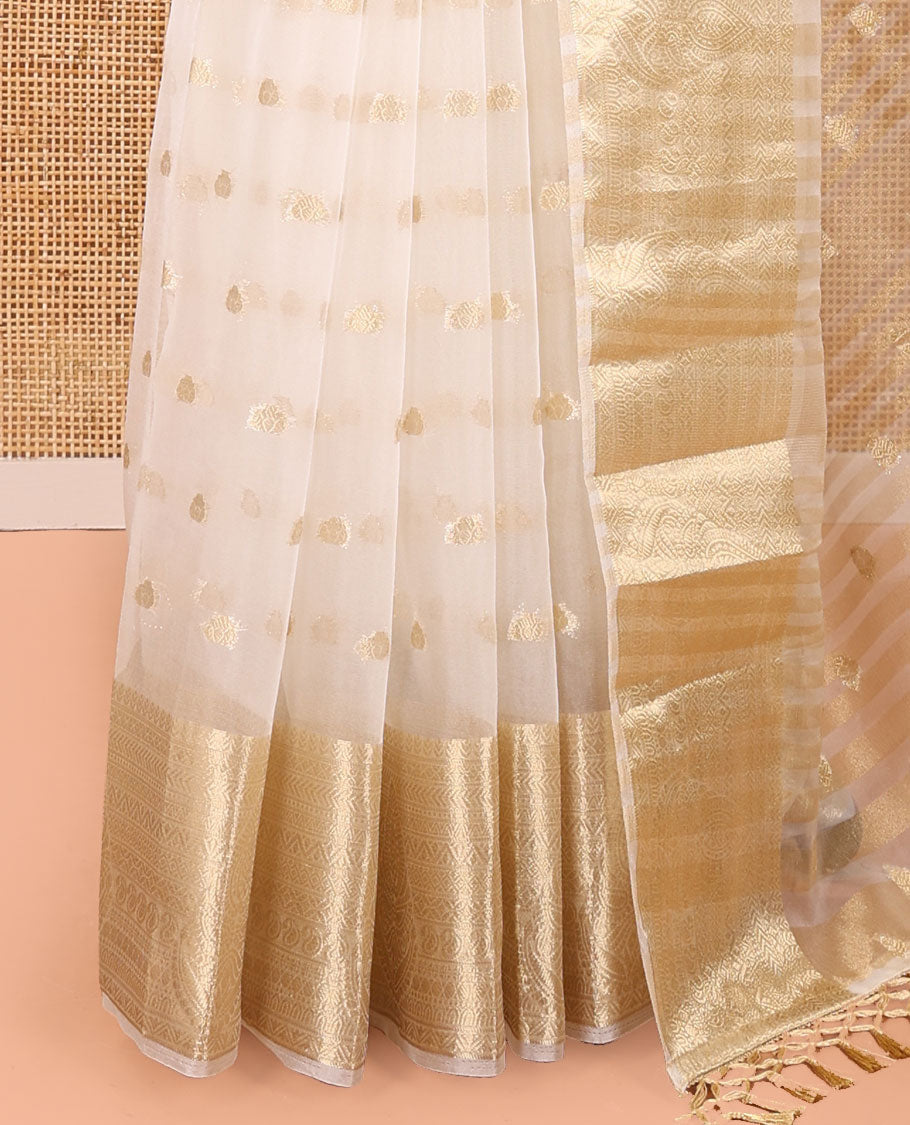 Cream Semi-Organza Saree, Shimmering with Zari Buttas All Over Its Body, Highlighted by a Traditional Zari Design Border, Gleaming Zari Design Pallu, and Paired with a Matching Blouse