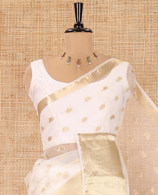 Cream Semi-Organza Saree, Shimmering with Zari Buttas All Over Its Body, Highlighted by a Traditional Zari Design Border, Gleaming Zari Design Pallu, and Paired with a Matching Blouse