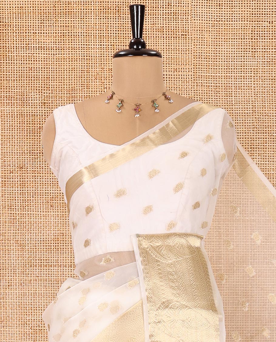Cream Semi-Organza Saree, Shimmering with Zari Buttas All Over Its Body, Highlighted by a Traditional Zari Design Border, Gleaming Zari Design Pallu, and Paired with a Matching Blouse