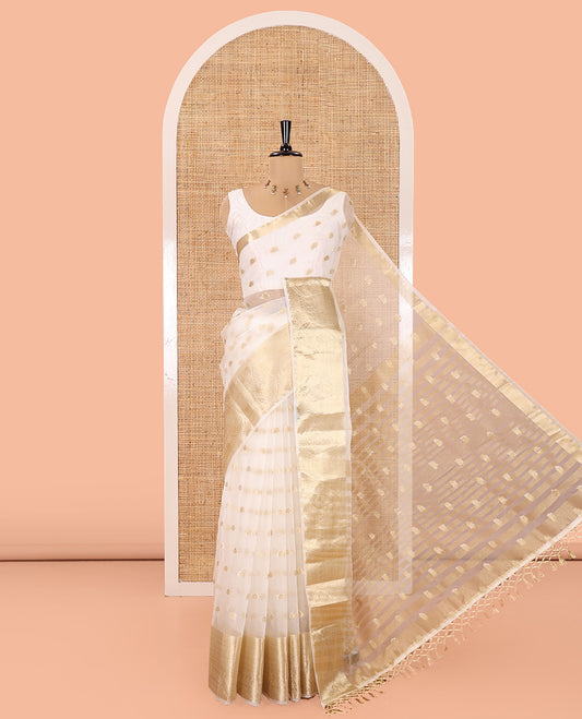 Cream Semi-Organza Saree, Shimmering with Zari Buttas All Over Its Body, Highlighted by a Traditional Zari Design Border, Gleaming Zari Design Pallu, and Paired with a Matching Blouse