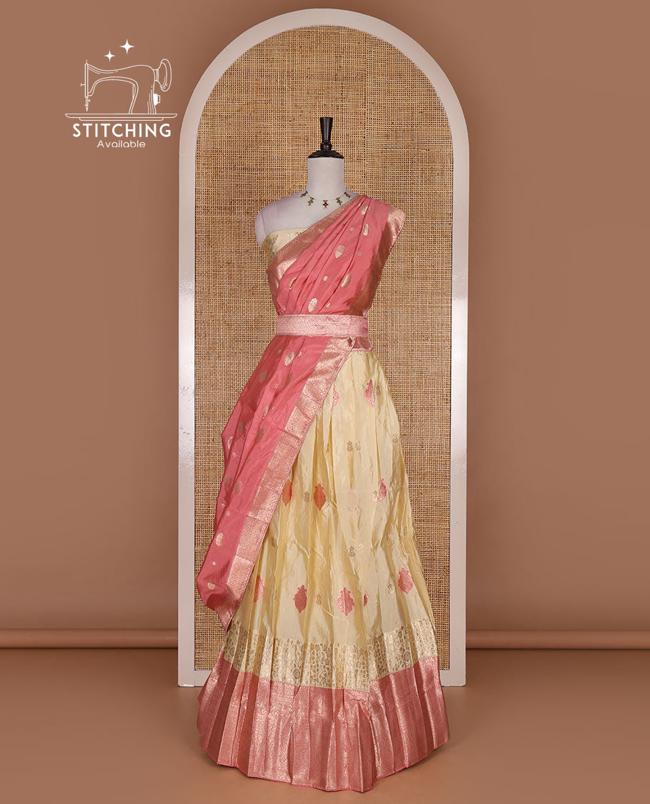 Cream taffeta silk half saree, meena buttas skirt, contrast pink traditional zari border, matching blouse, and zari woven dhavani