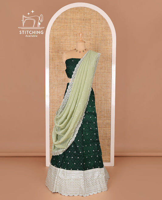 Green half-saree, floral motifs embroidered semi-raw silk top, matching embroidered blouse, and contrast scallop embroidered georgette dhavani